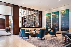 a lobby with a couch and a table and chairs at The Westin Memphis Beale Street in Memphis