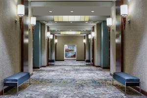 a hallway with chairs and a painting on the wall at The Westin Memphis Beale Street in Memphis