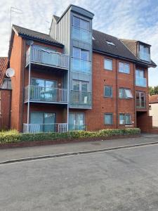 a large brick building on the side of a street at Vibrant City Center Studio Apartment 6a in Norwich