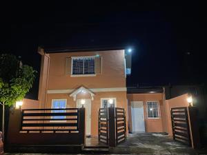 a house with a gate in front of it at night at JM Transient House in Butuan