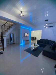 a living room with a couch and blue lights at JM Transient House in Butuan