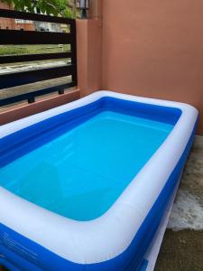 a pool in a house with a blue and white swimming pool at JM Transient House in Butuan