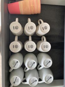 a drawer full of tea cups in a drawer at Whole house, Amohau St opposite Trade Central - 3 Bedrooms, Sleeps up to 6, 5 beds, wheel chair friendly in Rotorua