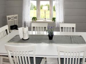 a dining room with a white table and chairs at 9 person holiday home in Åram in Sandvik