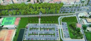 an aerial view of a parking lot with cars at CŒUR DU VENTOUX Carpentras Bel appart 6 places in Carpentras