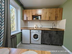 a kitchen with a washing machine and a sink at Квартира LUX in Balqash
