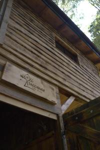 a sign on the side of a wooden building at Treehouse Velké Losiny in Velké Losiny