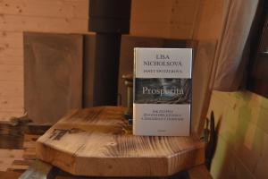 a book sitting on top of a wooden table at Treehouse Velké Losiny in Velké Losiny