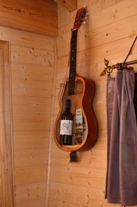 a guitar hanging on a wall next to a curtain at Treehouse Velké Losiny in Velké Losiny