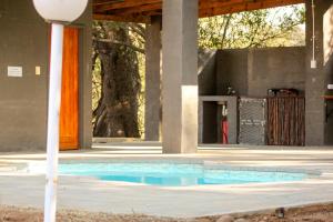 a swimming pool in the middle of a building at Bushriver Lodge in Mica