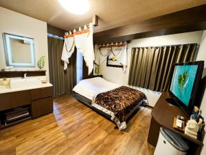 Postel nebo postele na pokoji v ubytování Hotel BaliBali Matsudo