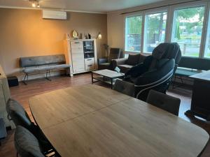 a large living room with a table and chairs at Sweet House with Sauna in Lieto