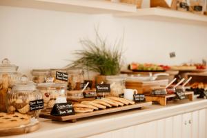 a buffet with bread and pastries on a counter at BAYIT Charming Place in Polignano a Mare