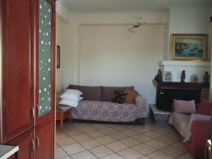 a living room with a couch and a fireplace at Studio eva in Palouki +6 photos