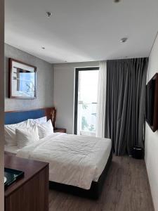 a bedroom with a large bed and a window at HL Houses Apec Phú Yên in Tuy Hoa