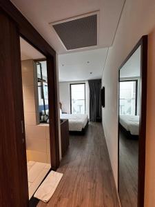 a room with two beds and a mirror at HL Houses Apec Phú Yên in Tuy Hoa +3 photos