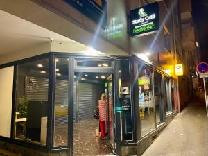 a woman is standing outside of a store at NEU Schwarzwald Zimmer am Schlössle Goldstadt Pforzheim in Pforzheim