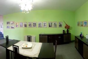 a dining room with a table and a green wall at La Taverna dei Colori in Laurino