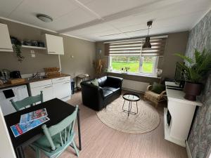 a living room with a couch and a table at Elefteria in Kolhorn