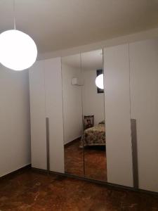 a mirror in a room with a room with a bed at Casa del Sole in Mondragone +29 photos