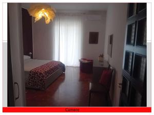 a bedroom with a bed and a window and a chair at Casa del Sole in Mondragone