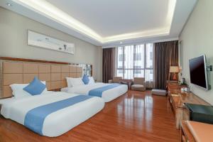 Ένα ή περισσότερα κρεβάτια σε δωμάτιο στο GuangZhou TongYu International Hotel