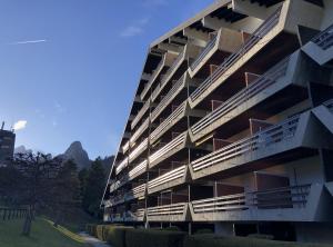 an apartment building with balconies on the side of it at Ravissant studio avec terrasse à Torgon in Vionnaz