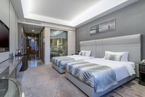 Ένα ή περισσότερα κρεβάτια σε δωμάτιο στο GuangZhou TongYu International Hotel