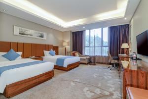 Ένα ή περισσότερα κρεβάτια σε δωμάτιο στο GuangZhou TongYu International Hotel