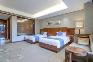 Ένα ή περισσότερα κρεβάτια σε δωμάτιο στο GuangZhou TongYu International Hotel