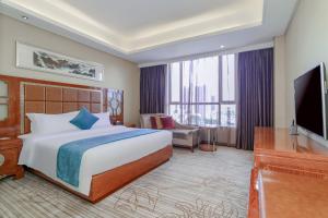 Ένα ή περισσότερα κρεβάτια σε δωμάτιο στο GuangZhou TongYu International Hotel