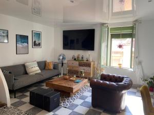 a living room with a couch and a coffee table at Appartement du sud in Saint-André-de-Sangonis