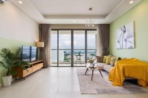 a living room with a couch and a tv at Diamond Island - Mekong Retreat Apartment in Ho Chi Minh City +17 photos