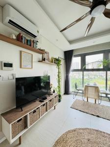 a living room with a large flat screen tv at Diamond Island - Mekong Retreat Apartment in Ho Chi Minh City