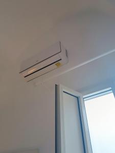 a ceiling light in a room with a window at Domus Donata in Galatone