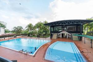 a large swimming pool with a tennis court and a building at Seri Mutiara JB #3Bedrooms #8pax #Family in Johor Bahru