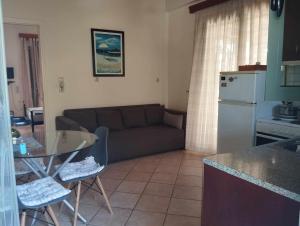 a living room with a couch and a table at Studio eva in Palouki