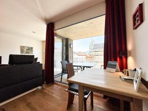 a living room with a table and a couch at Staufner Maisonette in Oberstaufen