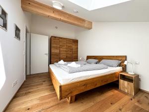 a bedroom with a large bed with a wooden headboard at Staufner Maisonette in Oberstaufen