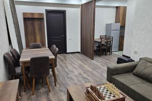 a living room with a couch and a table with chess at Stay with us in Mtskheta K2 #3 in Mtskheta