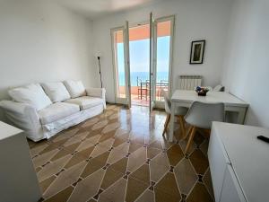 a living room with a couch and a table at Panorama - By Ligooria in Pietra Ligure