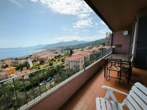 a balcony with a table and chairs and a view at Panorama - By Ligooria in Pietra Ligure