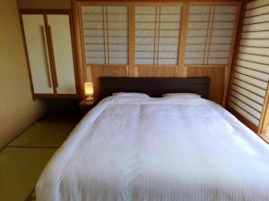 Voodi või voodid majutusasutuse Sasakura onsen Ryuunso toas