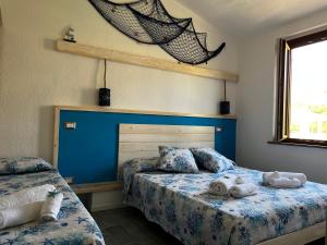 Ένα ή περισσότερα κρεβάτια σε δωμάτιο στο Attico aMare Costa Rei - 100m dalla spiaggia
