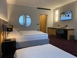 Letto o letti in una camera di HABAKUK Wellness & Event Hotel