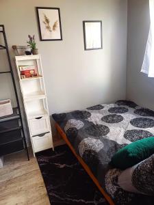a bedroom with a bed and a book shelf at Leśne Zacisze domki letniskowe in Lipnica