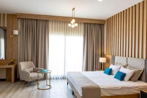 Postel nebo postele na pokoji v ubytování PARADISOS HOTEl