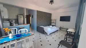 a kitchen and a living room with a bed and a table at Homico 2 Lefokastro in Lefokastro
