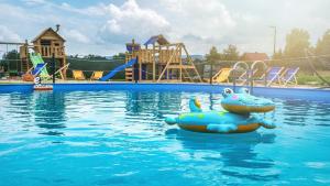 a pool with an inflatable hippo in the water at Apartament z prywatną sauną i widokiem na Tatry SKIBUS Kulkolandia Sala Zabaw Balia in Białka Tatrzanska