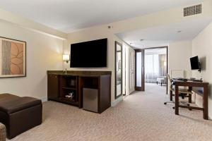 a hotel room with a flat screen tv and a desk at DoubleTree by Hilton Washington DC – Crystal City in Arlington